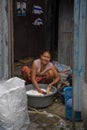 A woman living in a slum doing laundry